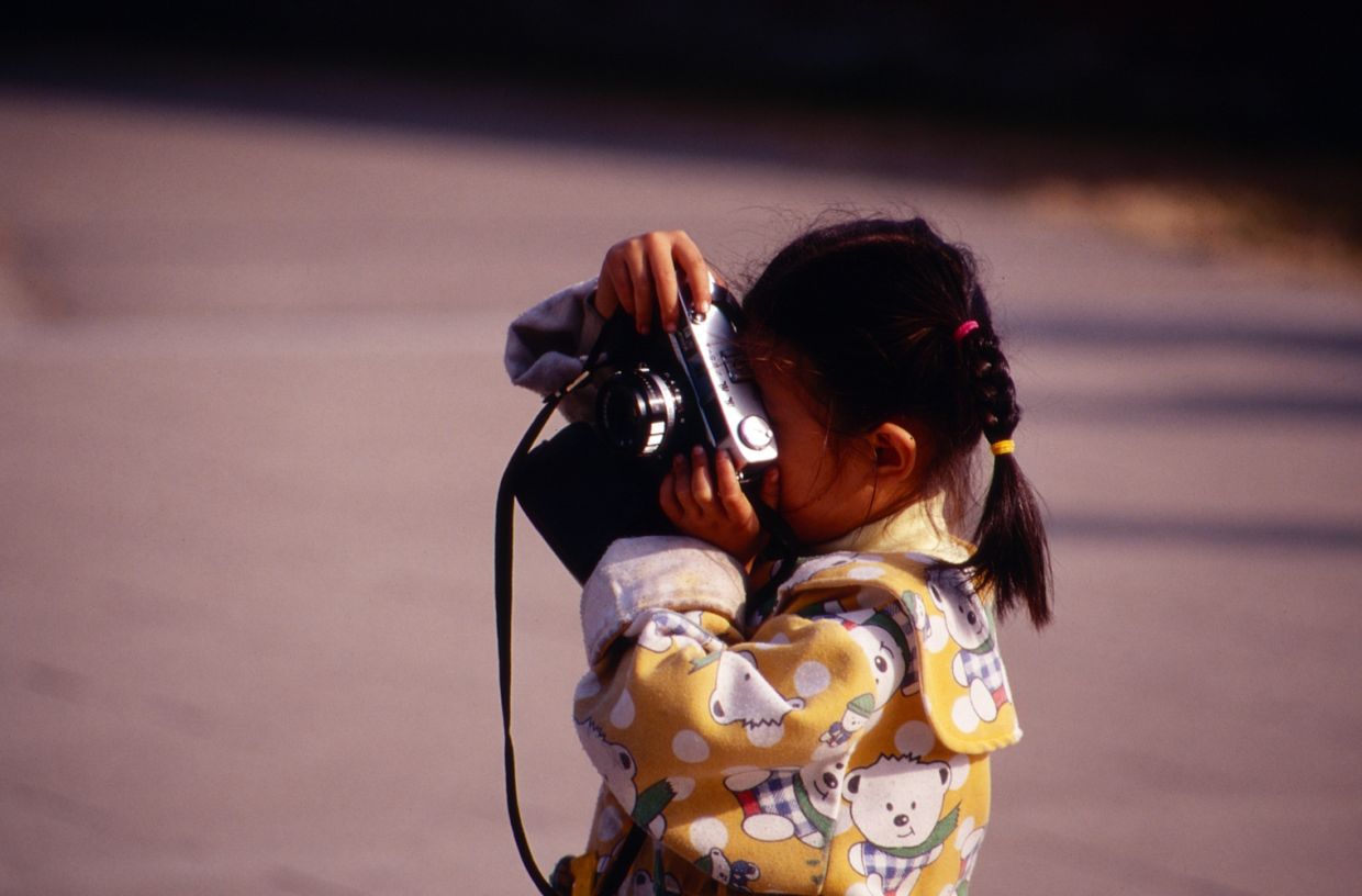 A child with a camera