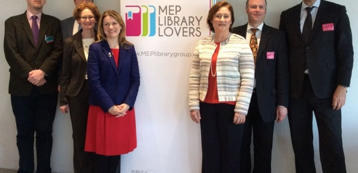 A group of seven people standing indoors beside a banner that reads "MEP Library Lovers."