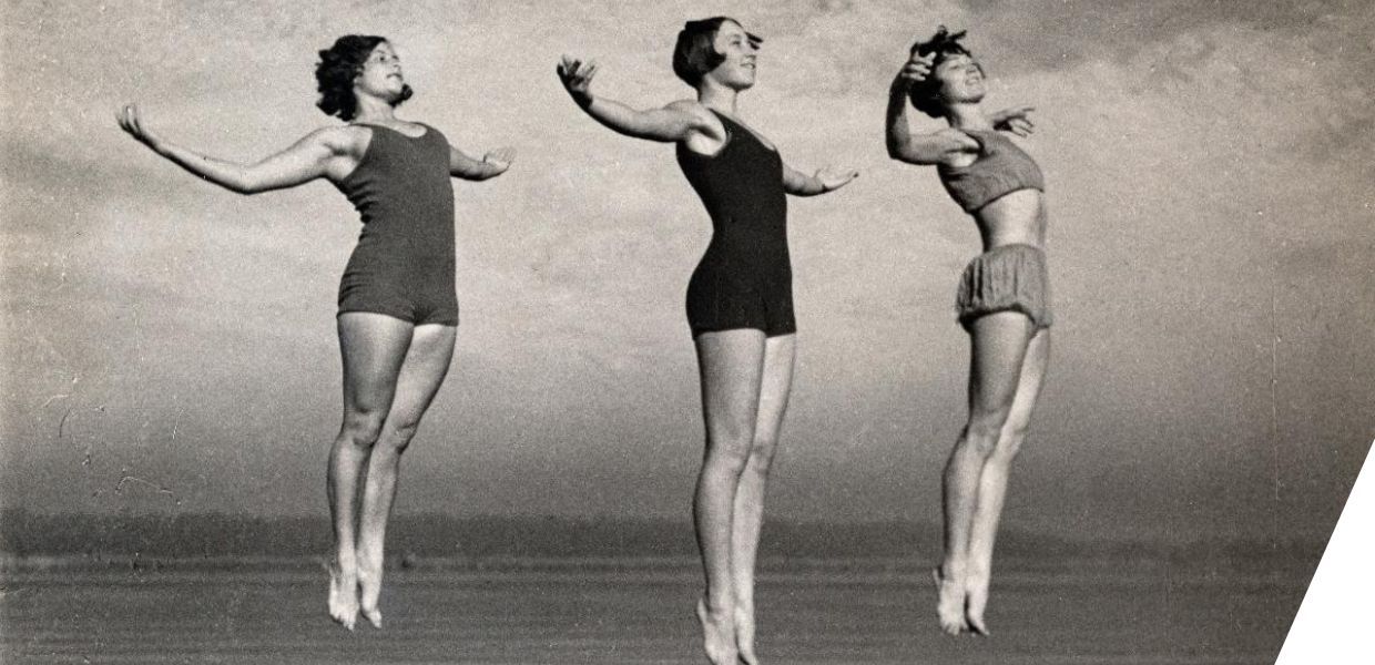 Three women leaping into the air