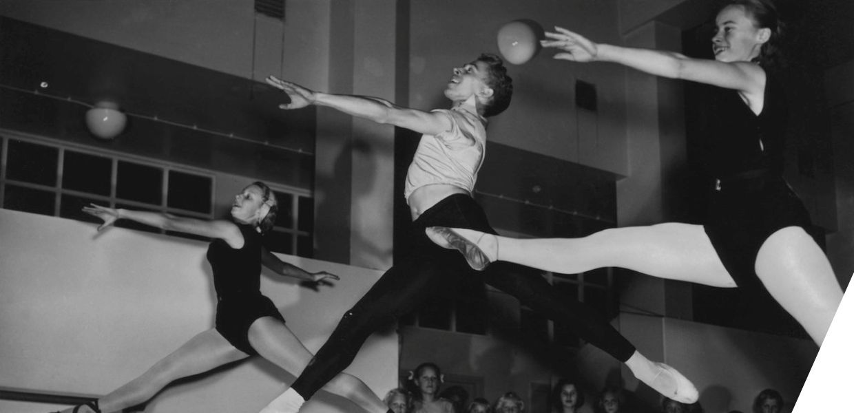 Three dancers leaping into the air