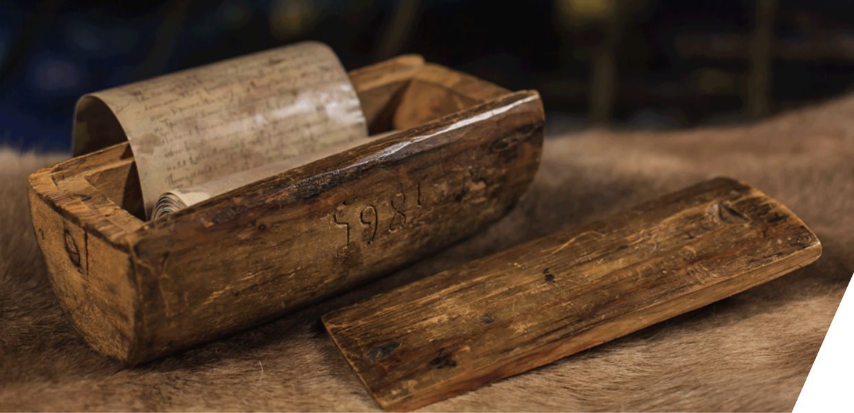  A curved wooden box with manuscripts within
