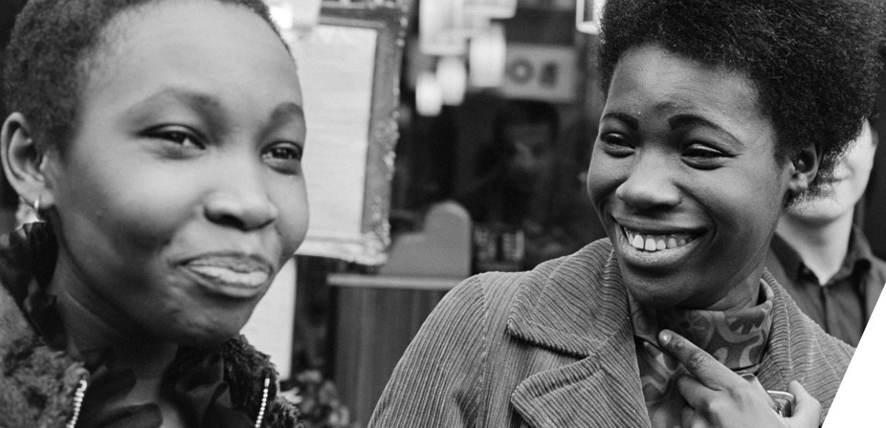 Two young Black women smiling