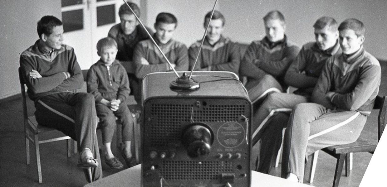 A group of boys sat watching television