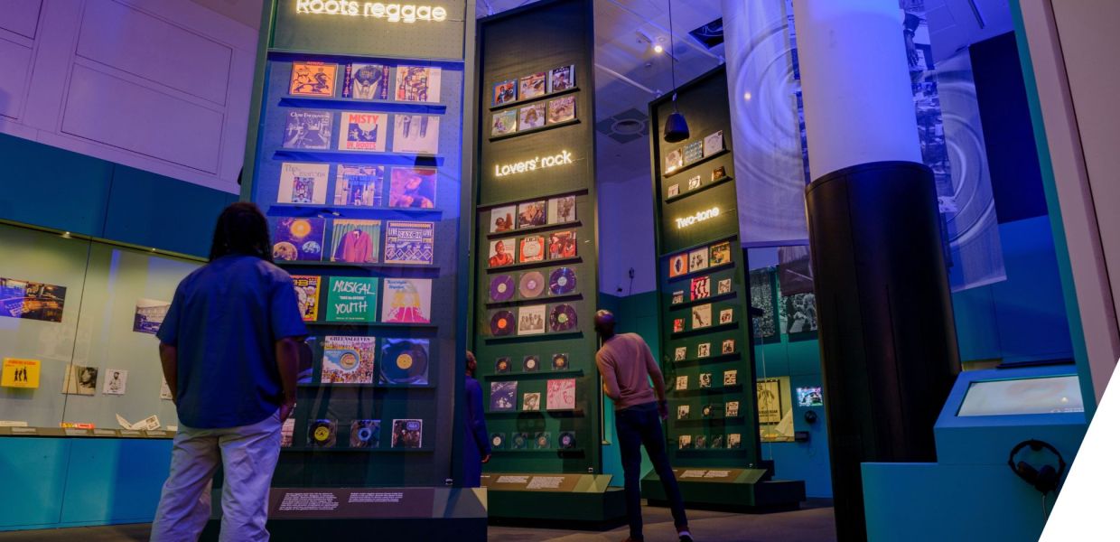 People looking at shelves of record sleeves in an exhibition