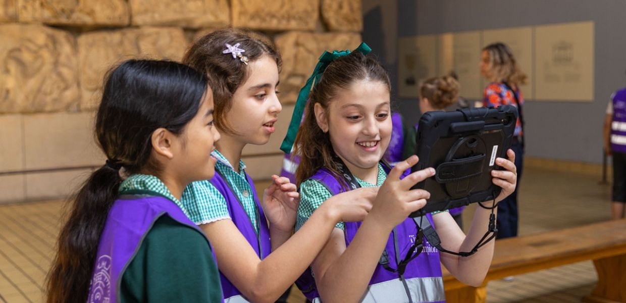Children interact with Time Odyssey through a tablet. 