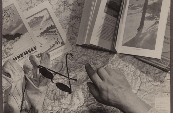 Sunglasses and guidebooks placed on top of a map